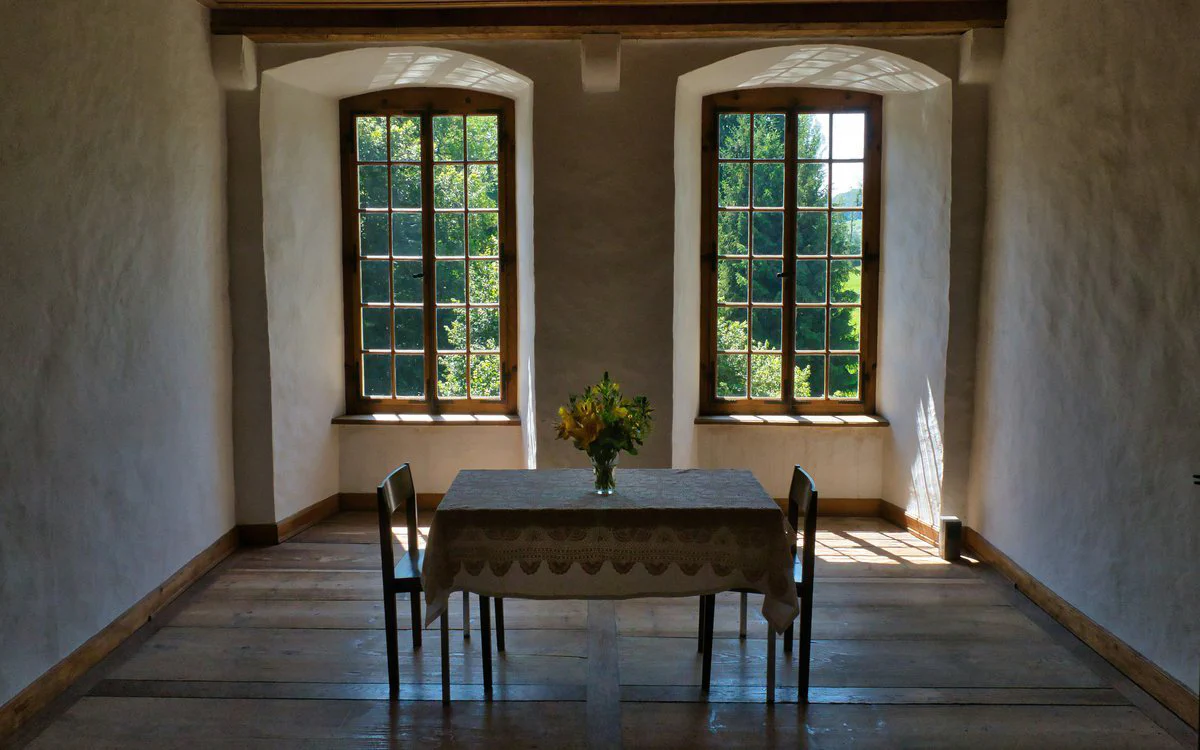 Clean, minimalist room with single candle placed at eye level for tratak meditation