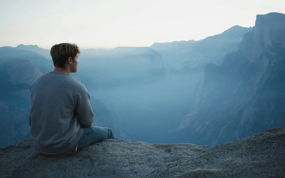 Person meditating peacefully with candle